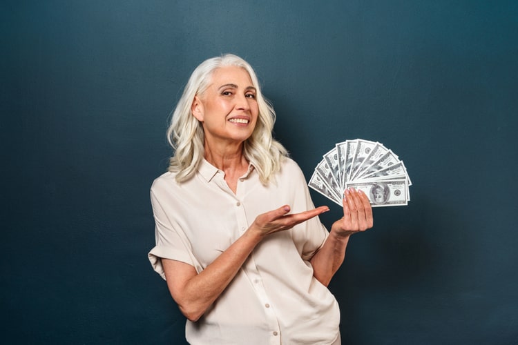 Business woman holding cash.