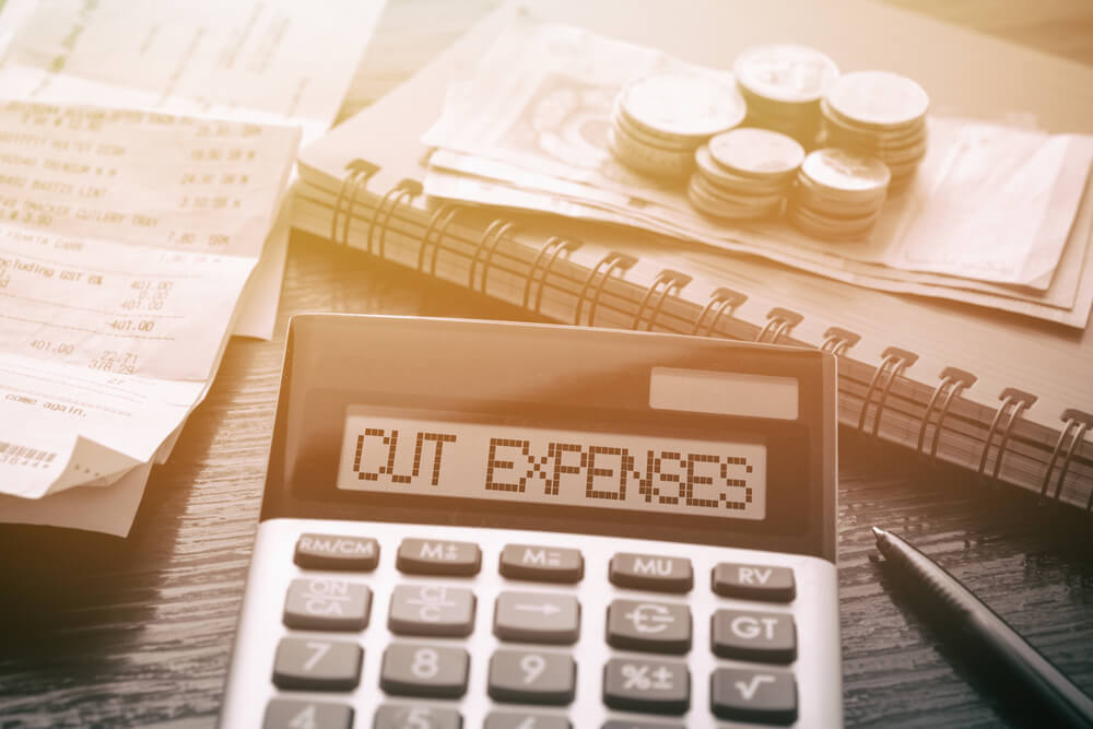 business expenses cut half 