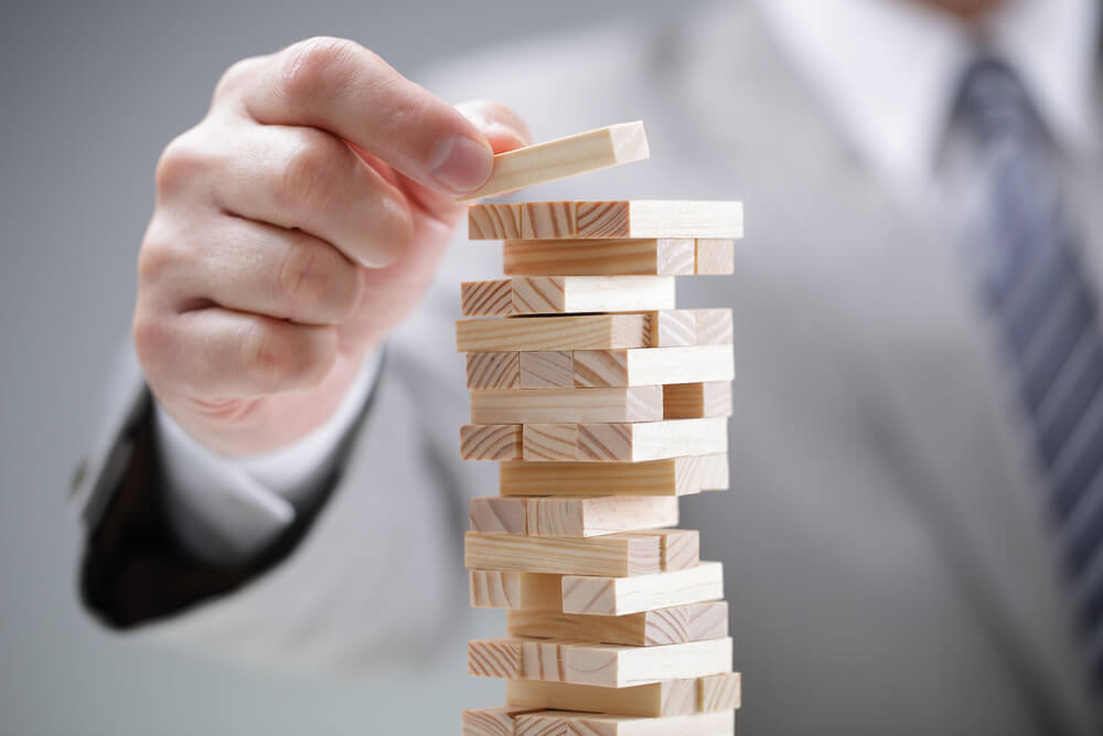 Business man stacking building blocks