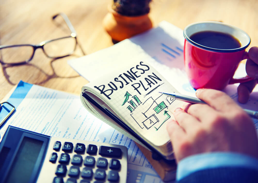 reasons-why-you-need-business-plan.jpg Drinking coffee while coming up with a business plan.